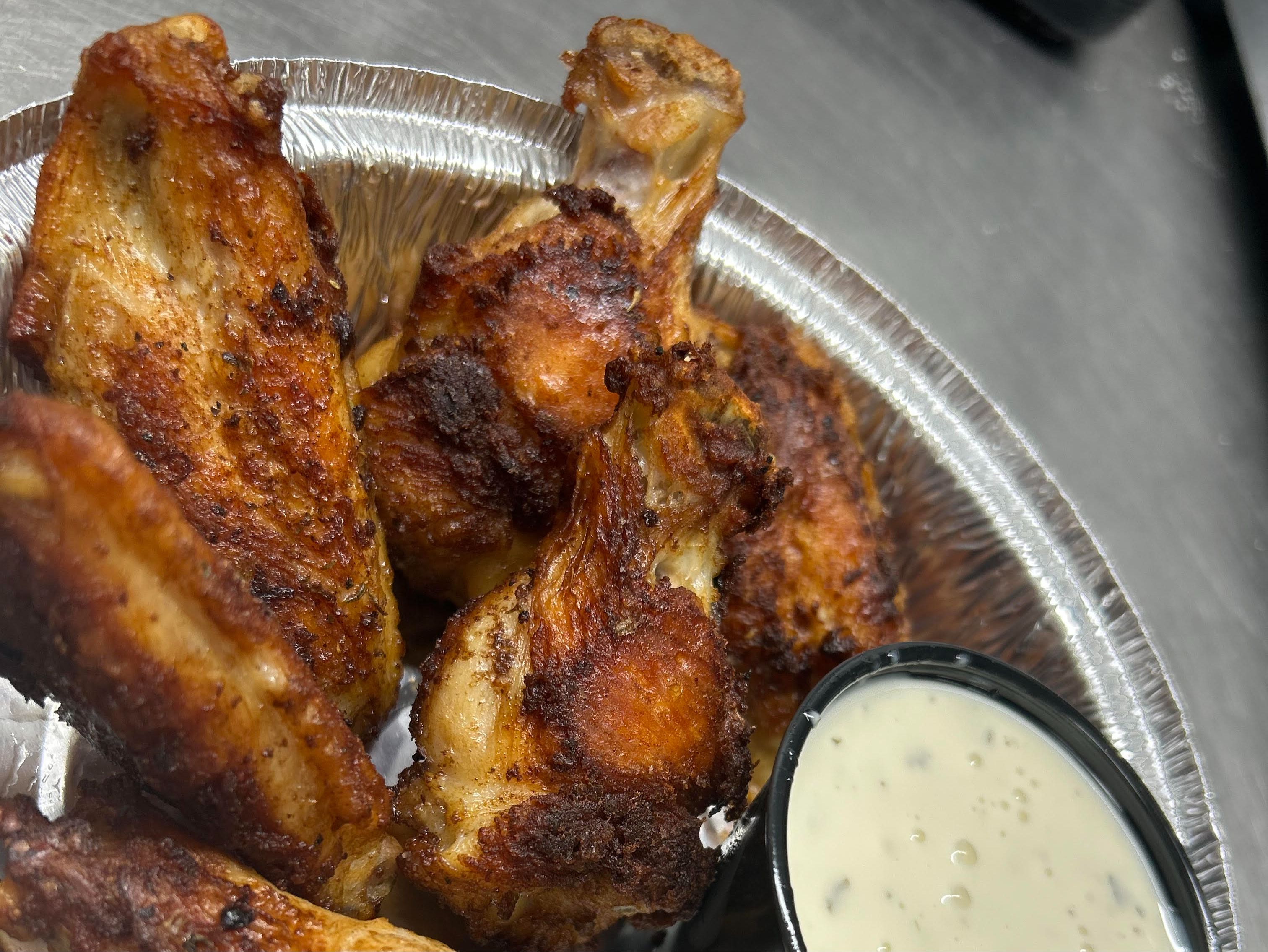 6 Bone in wings (Sauce on side sold separately).