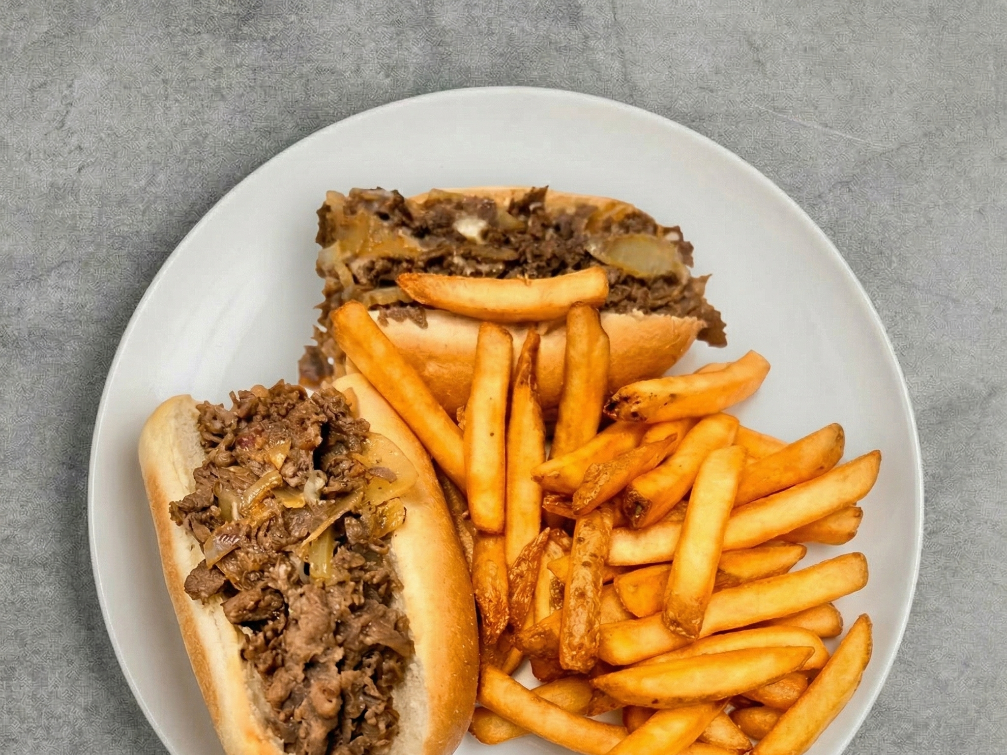 Cheesesteak With Fries & Canof Soda.