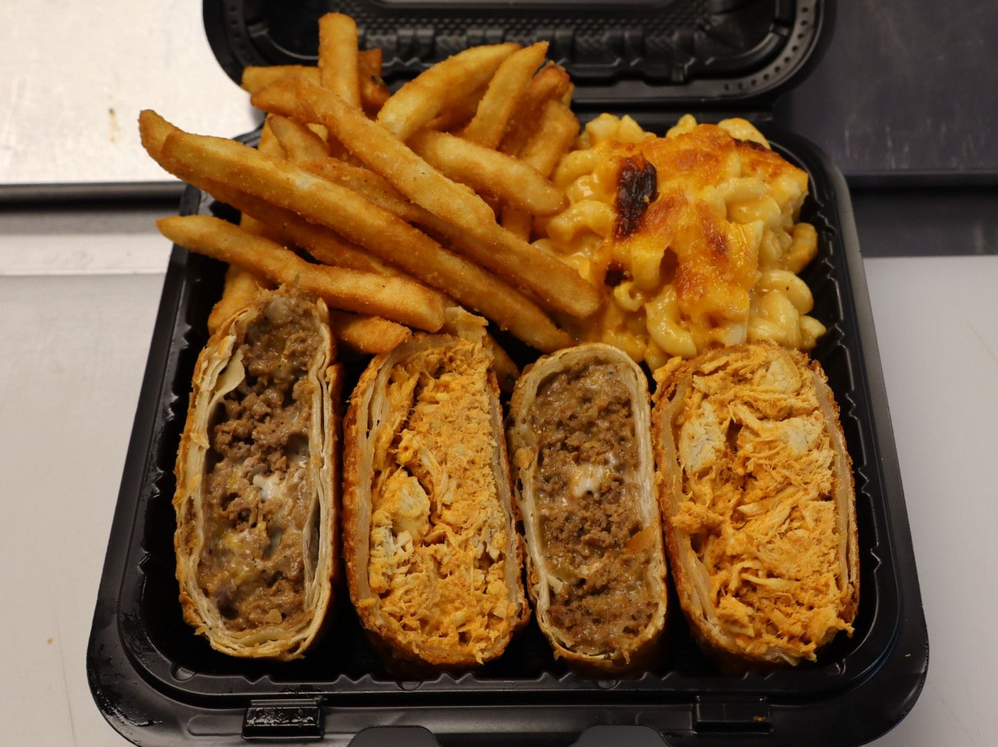 Half Buffalo Chicken & Half Cheesesteak with Two Sides.