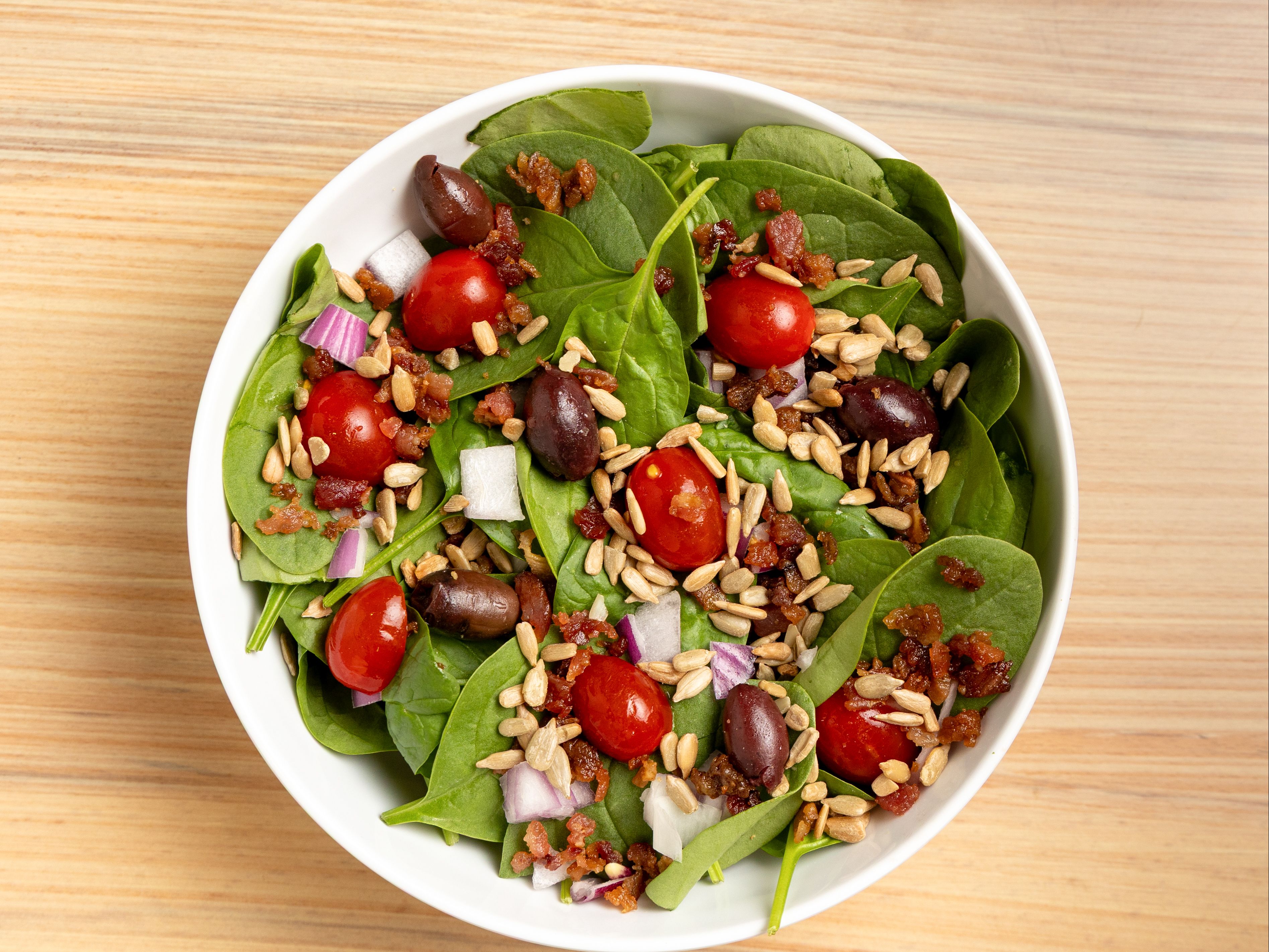 Spinach Sup - Spinach, Red Onions, Grape Tomato, Kalamata Olive, Diced Eggs, Sunflower Seeds, Bacon with Poppyseed Dressing