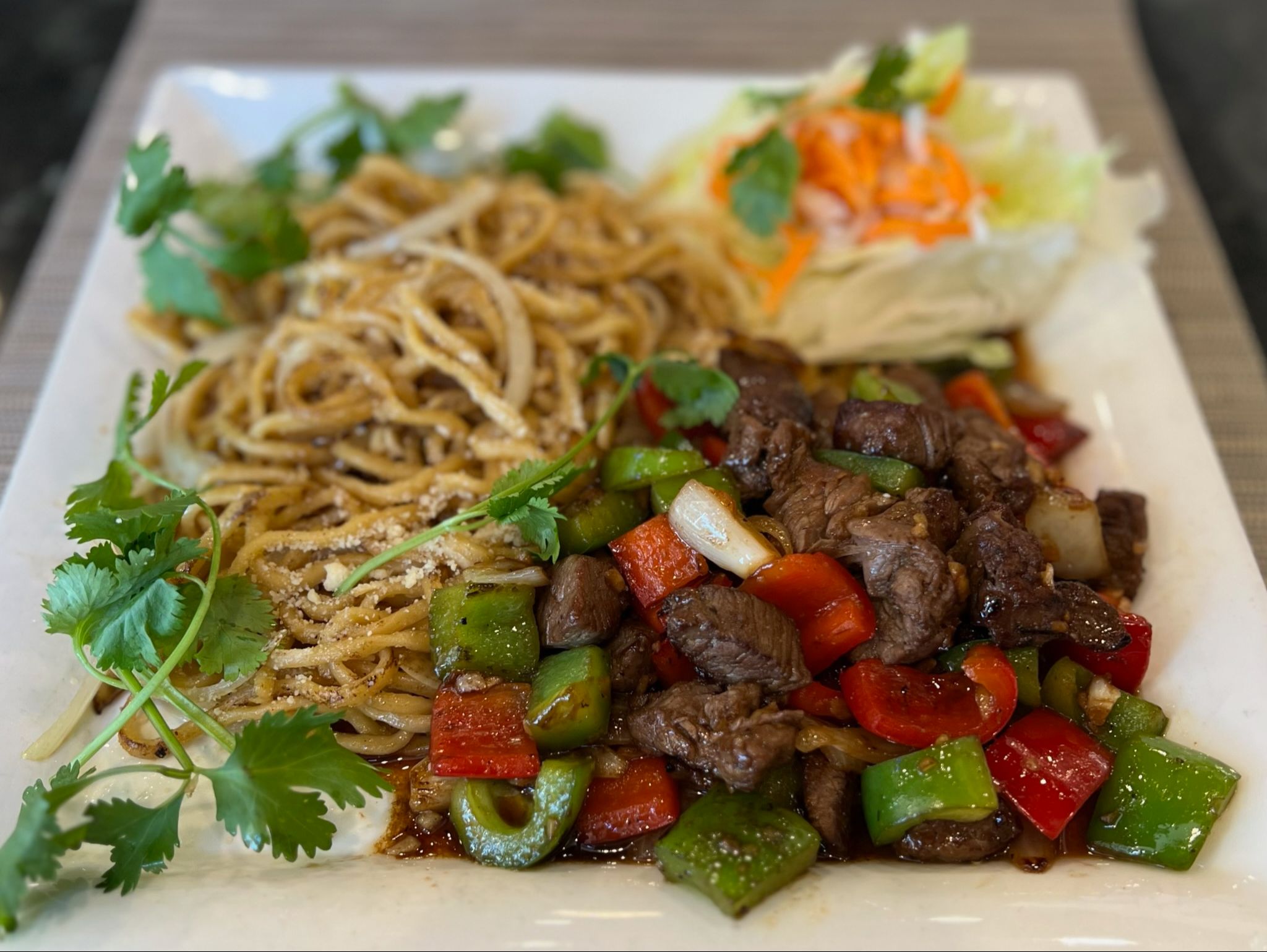 M99. Shaken Beef over Garlic Noodles.