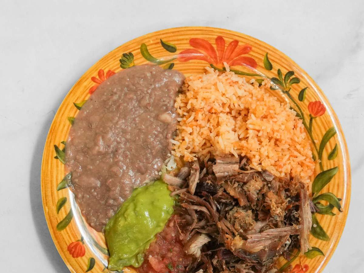 Carnitas, Salsa, Guacamole, Rice & Beans.