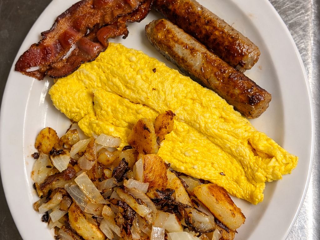Two Eggs, Two Country Sausages & Bacon Slices, Home Fries and Toast.