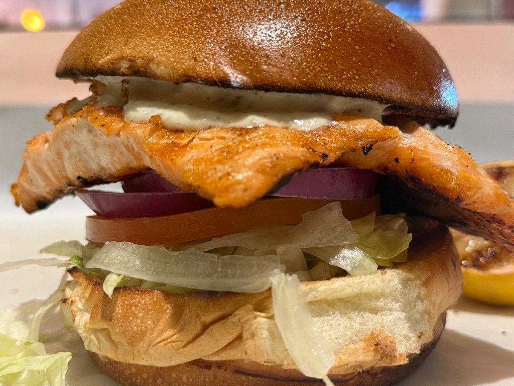 On a Burger Bun. With Lettuce, Tomato, Onion and Tartar Sauce.