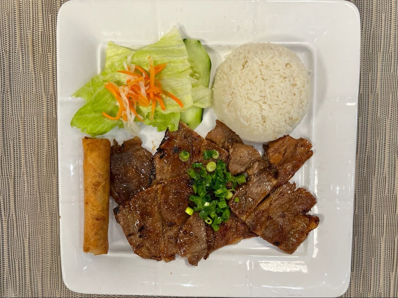 C66. Rice w/ Grilled Pork, Egg Roll.