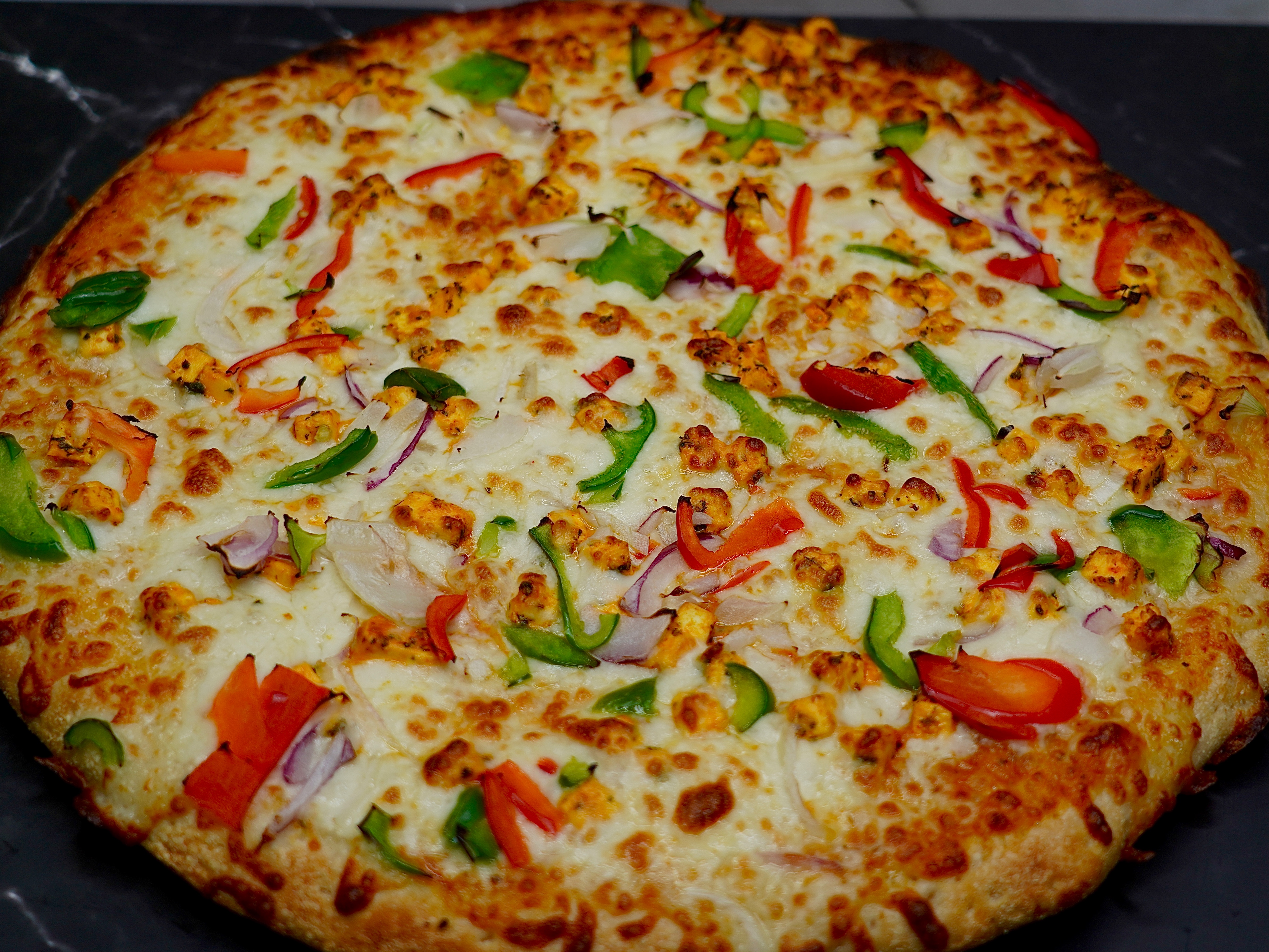 Paneer/chicken Tikka Masala Pizza.