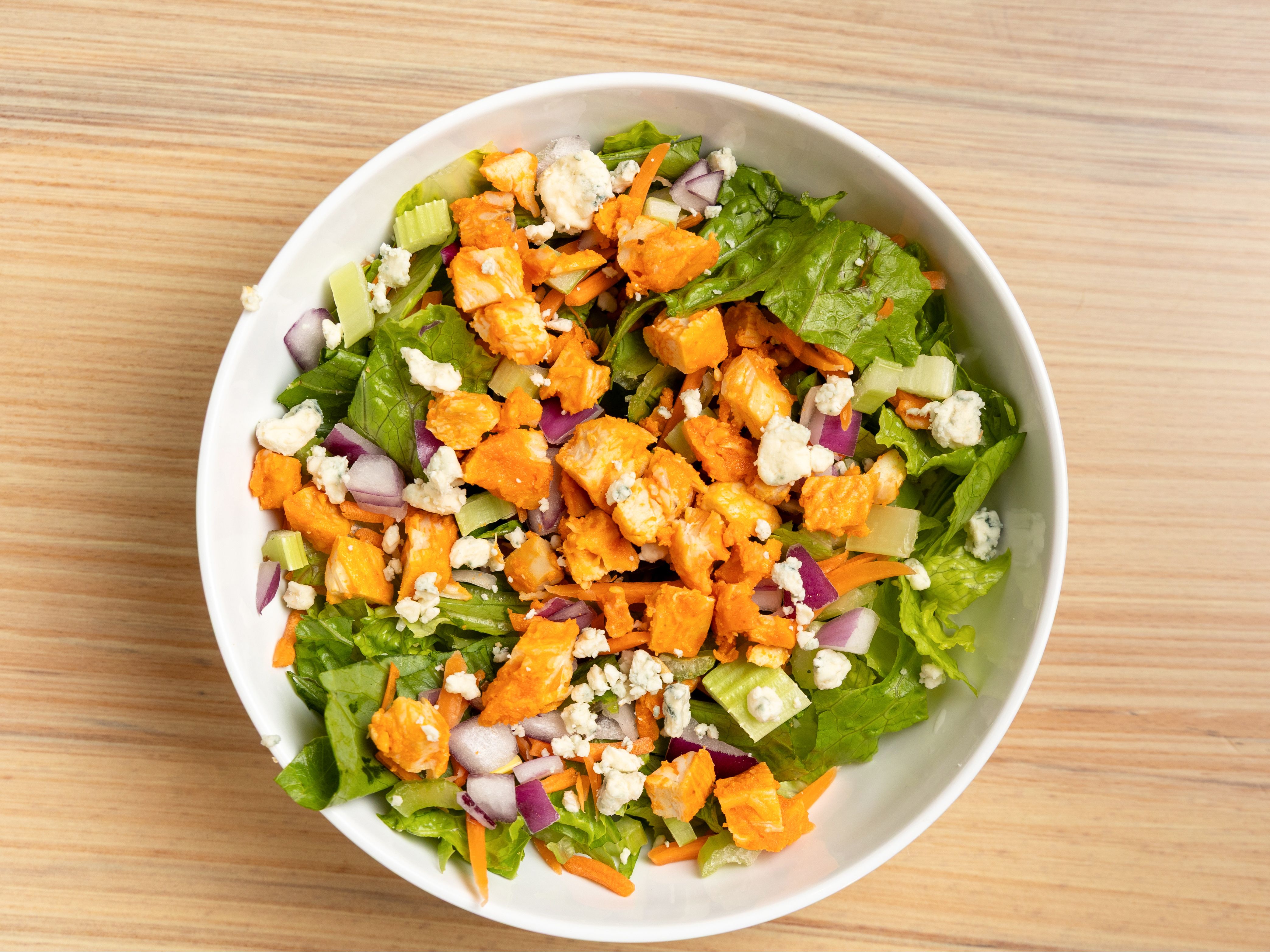 Red Roost - Romaine, Celery, Carrots, Red Onions, Blue Cheese Crumbles, Buffalo Chicken, Blue Cheese Dressing