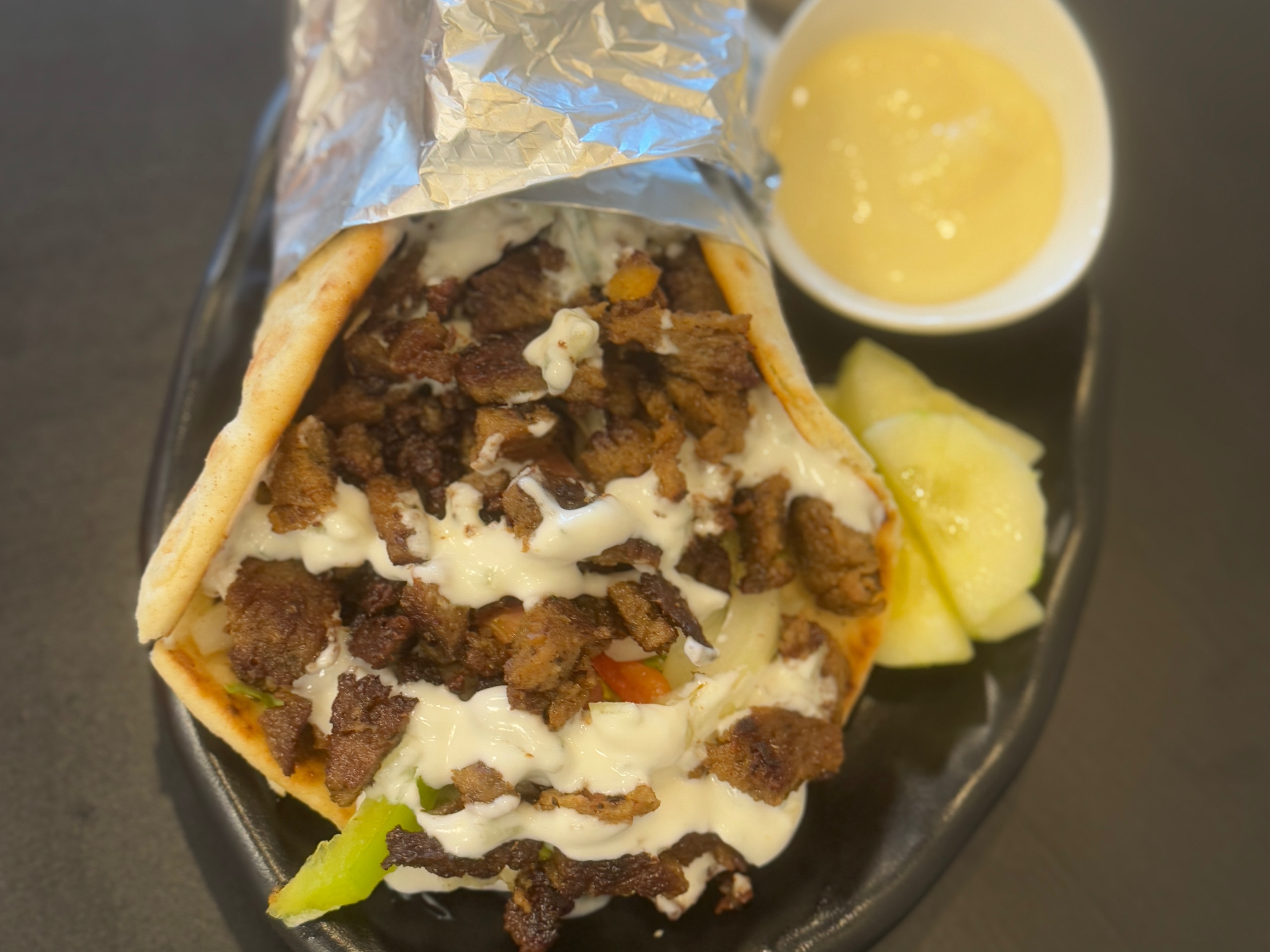 Beef Gyro Wrap ( Beef,Bread,Lettuce,tomato,onion,pepper,sharjah Tzatziki Sauce)