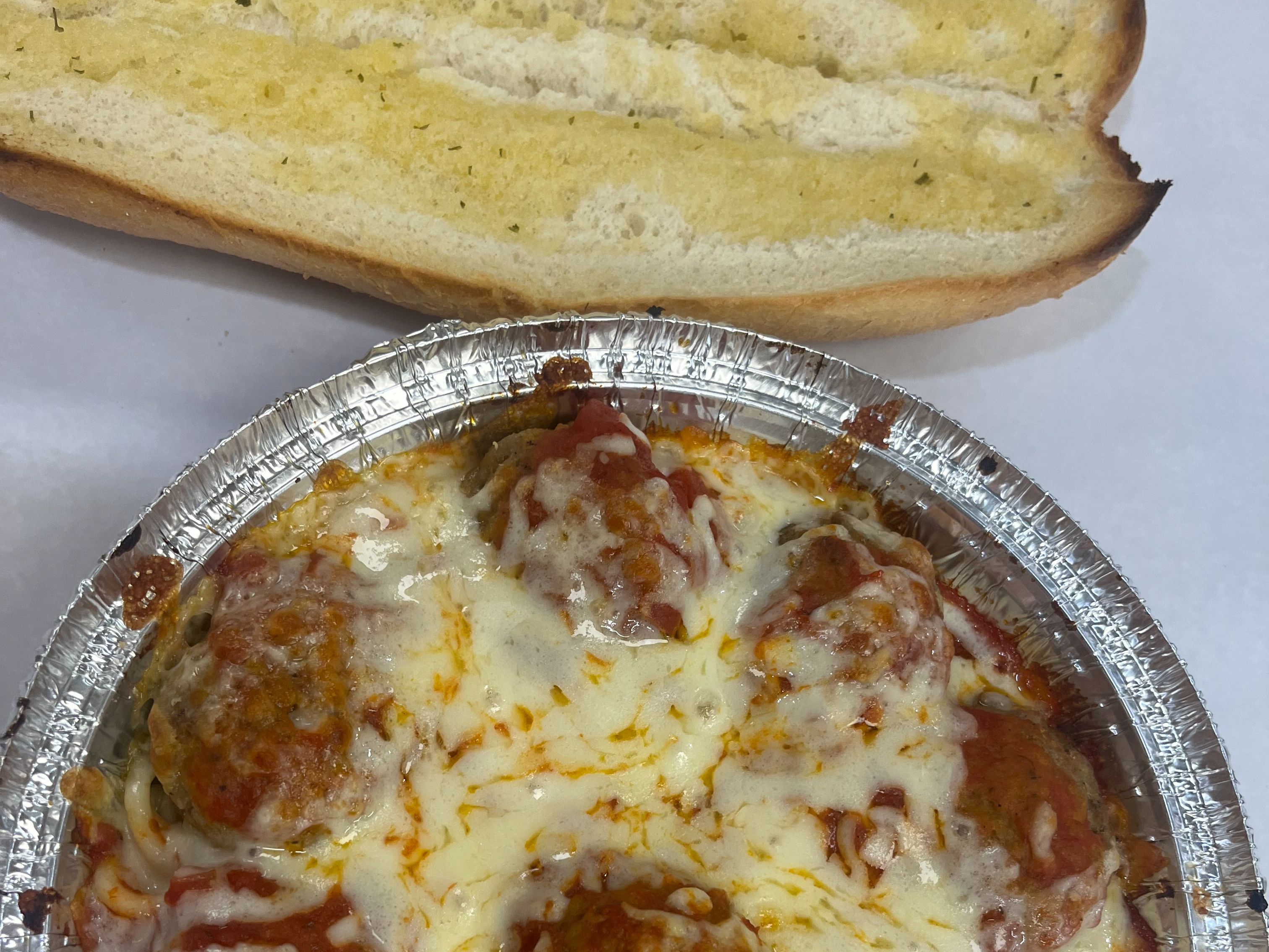 Meatball Parm Pasta served with garlic bread