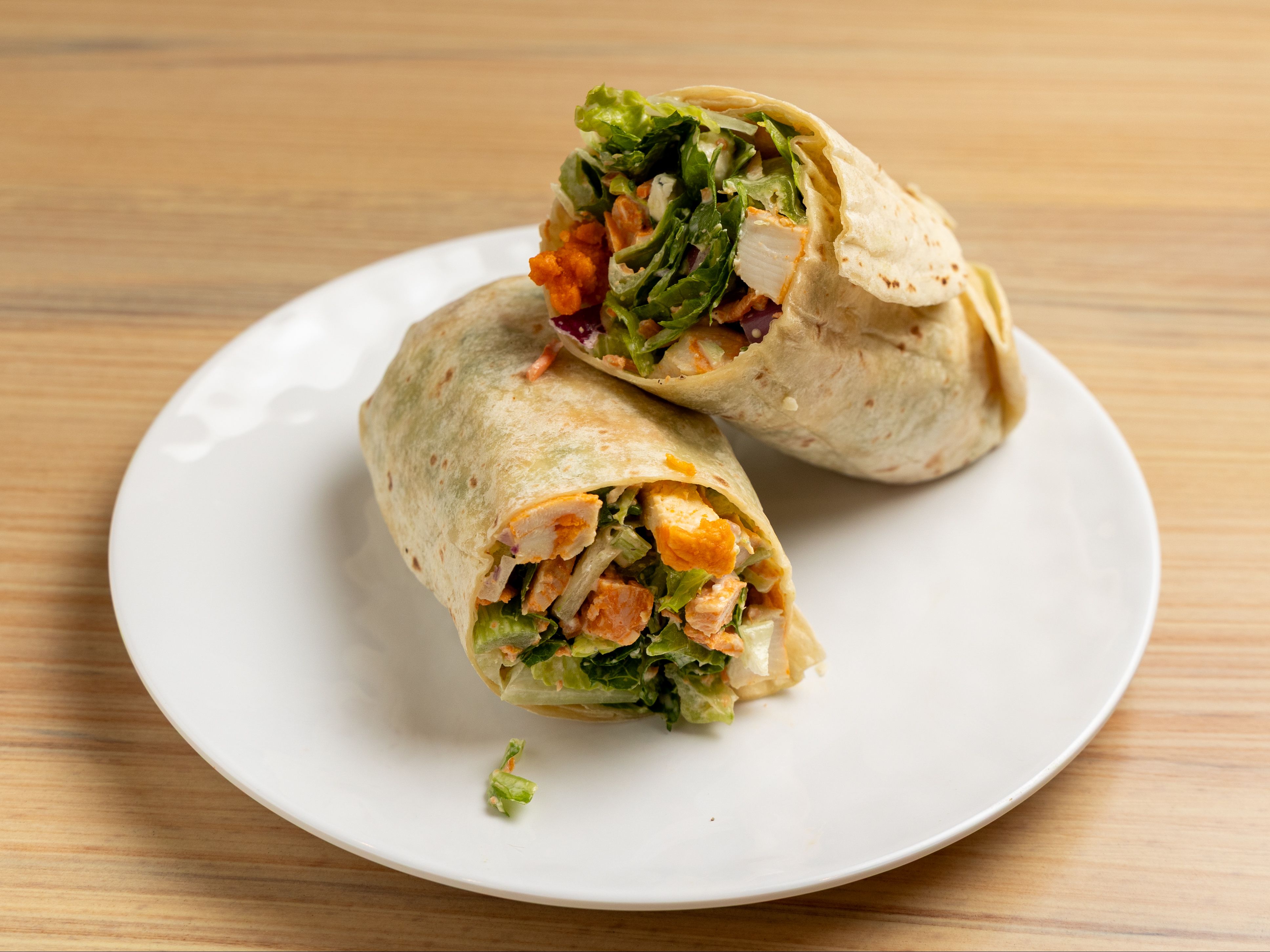 Buffalo Chicken Wrap - Romaine, celery, carrot, red onion, blue cheese crumble, spicy buffalo chicken with Blue Cheese dressing