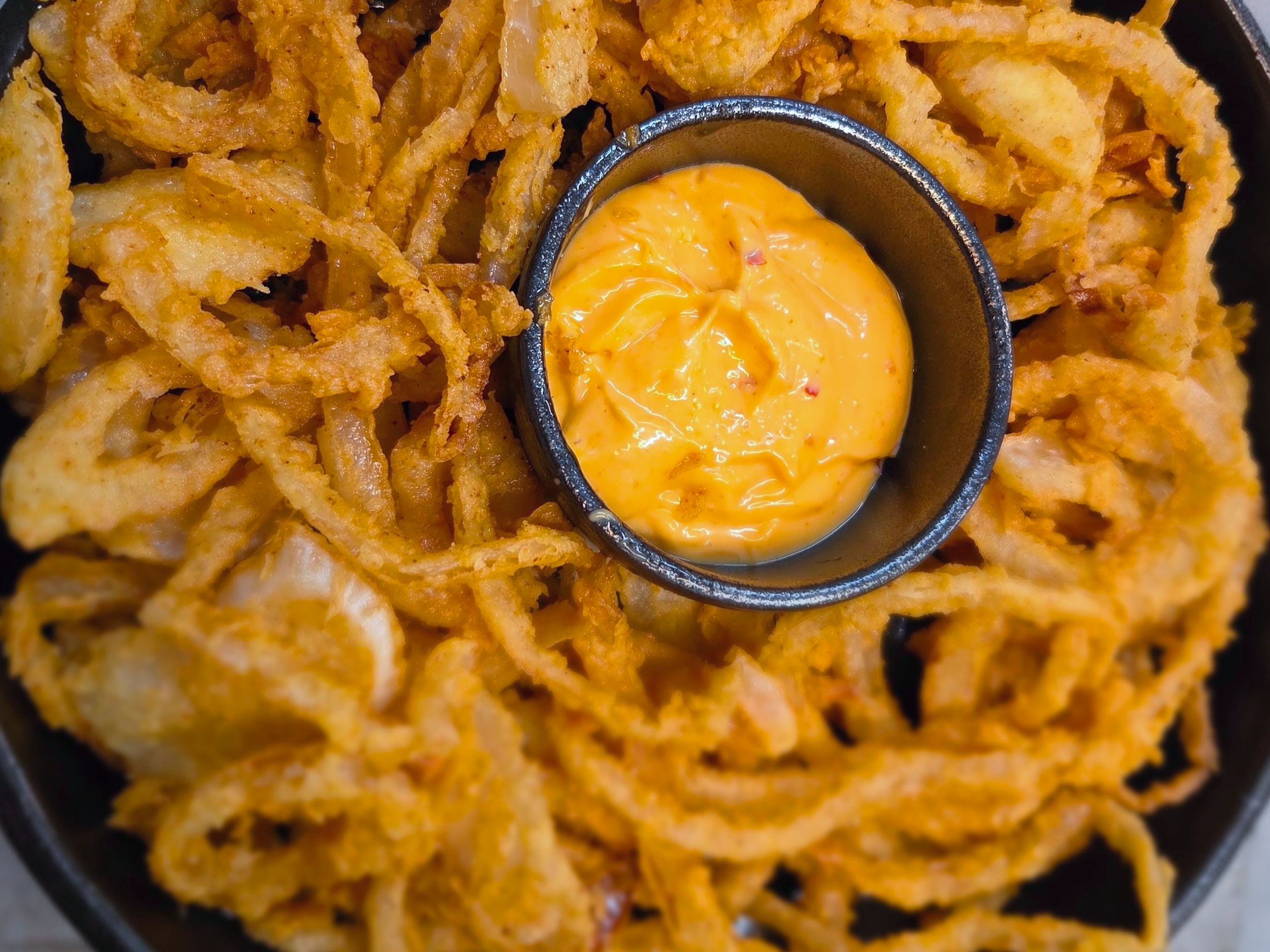 Onion Strings With Sweet Chili Mayo Sauce.