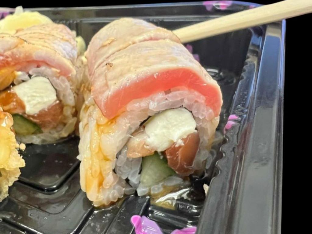 Pilot Dan Roll - Made of salmon, cream cheese and cucumber inside, …na on top with eel sauce and special wasabi sauce.