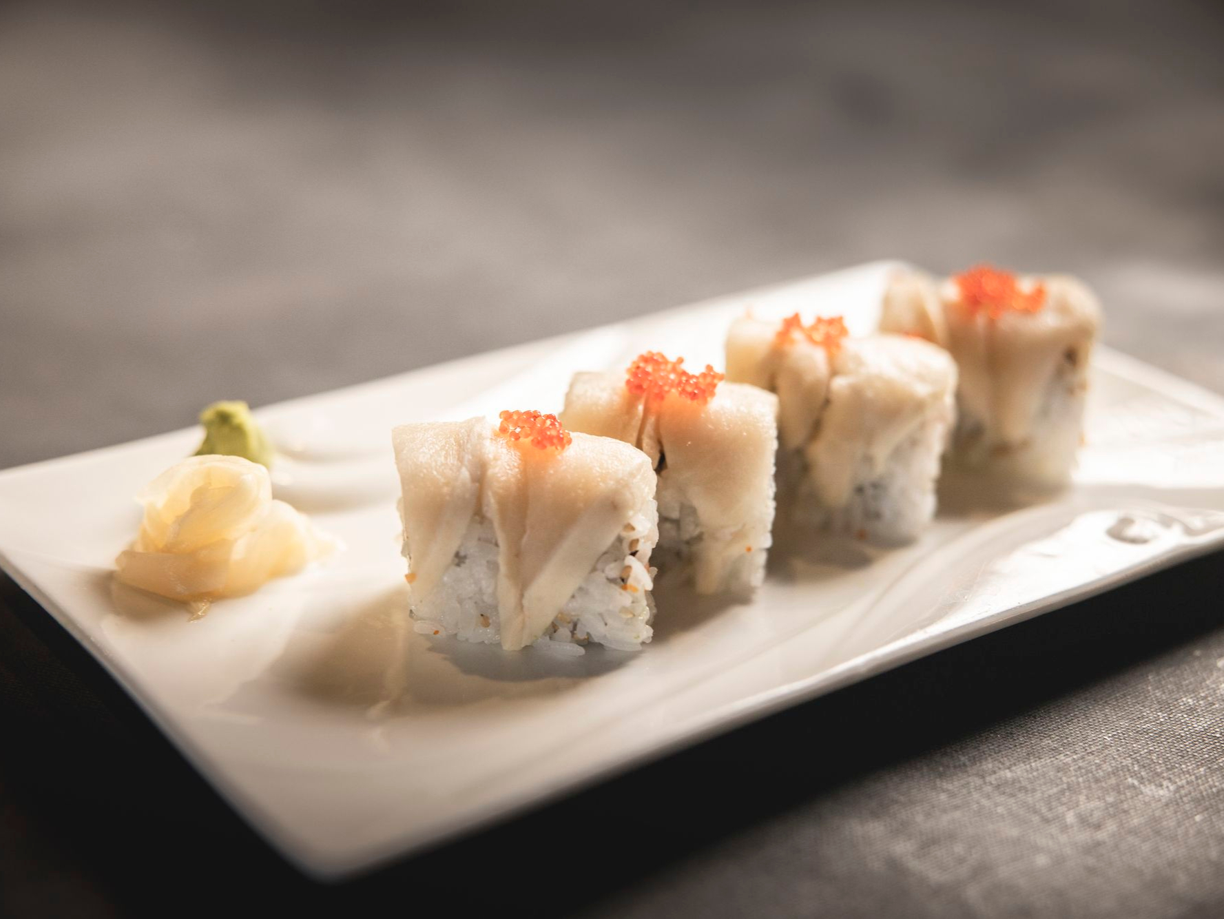 Sexy Mermaid Roll - Smoked salmon, cream cheese and avocado inside, topped with tuna, white tuna and red tobiko.