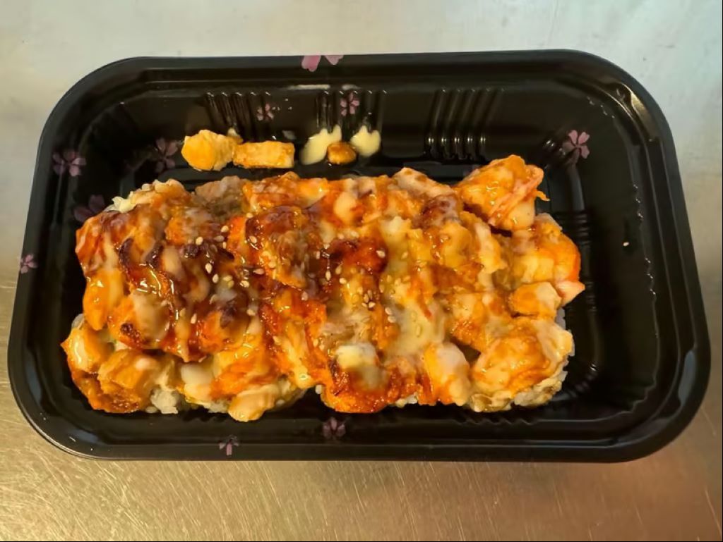 Mt Trashmore - Toasted salmon and red snapper in dynamite sauce mounted on top of avocado cucumber roll.