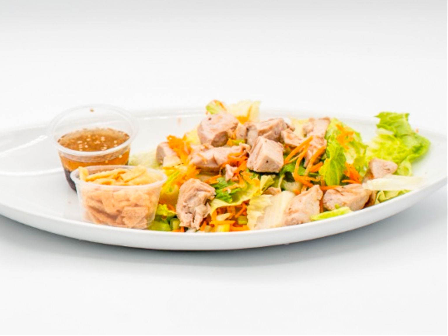 Fresh Ahi Salad from Yama's Fish Market — Locally caught ahi served over a bed of lettuce with cucumbers and our housemade dressing — light but hearty, island-style.