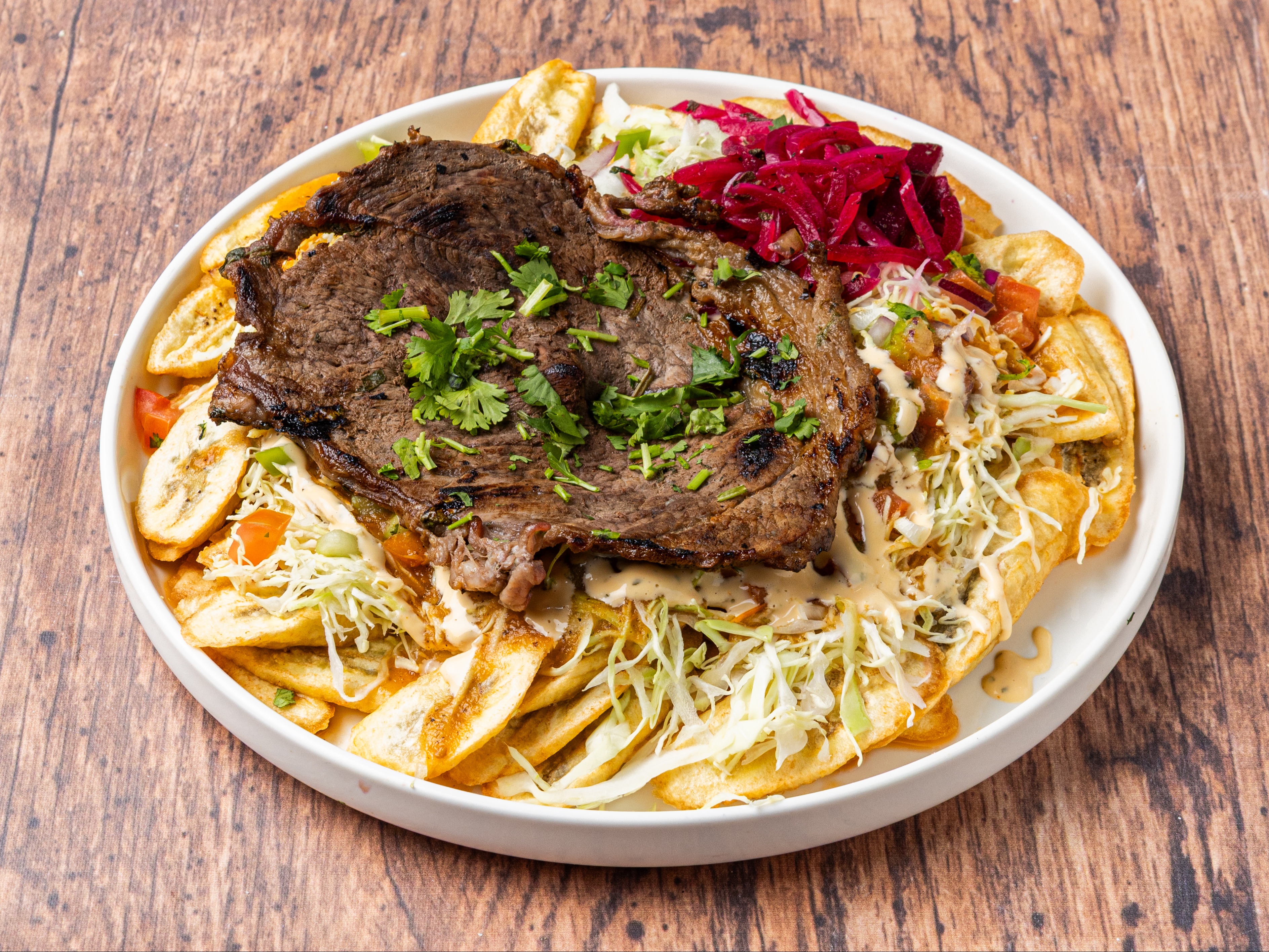 Carne Asada Plate withTajadas & Cabbage Salad.