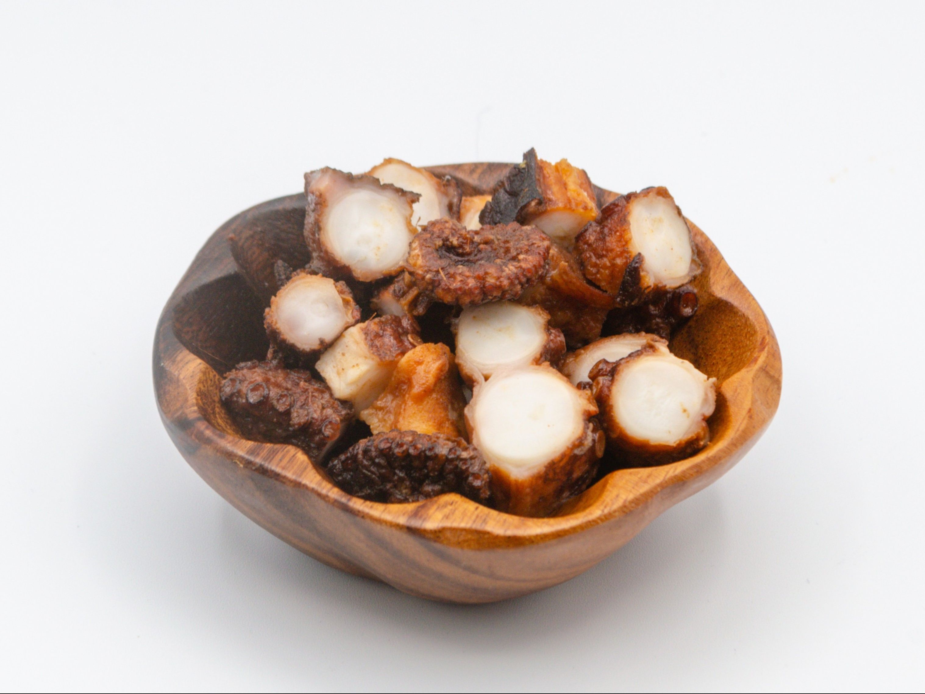 Pulehu Tako from Yama's Fish Market — Tender octopus marinated and grilled over open flame in traditional Hawaiian pulehu style. Finished with sea salt, garlic and ginger for a smoky, savory bite with crisp edges.