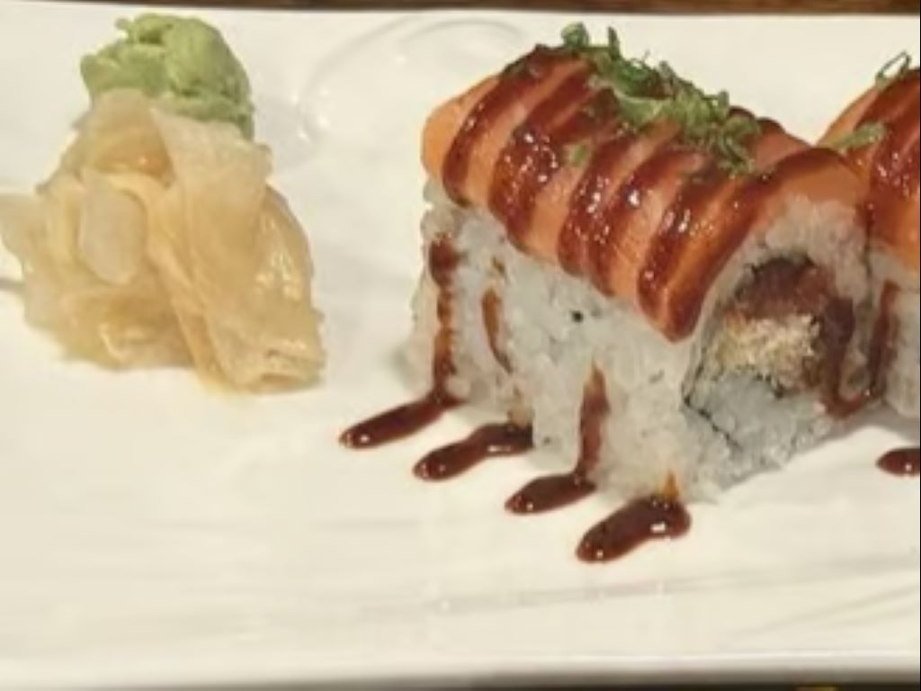 SR15. Monster Roll - Spicy tuna roll topped with slices of fresh salmon & house spicy sauce.