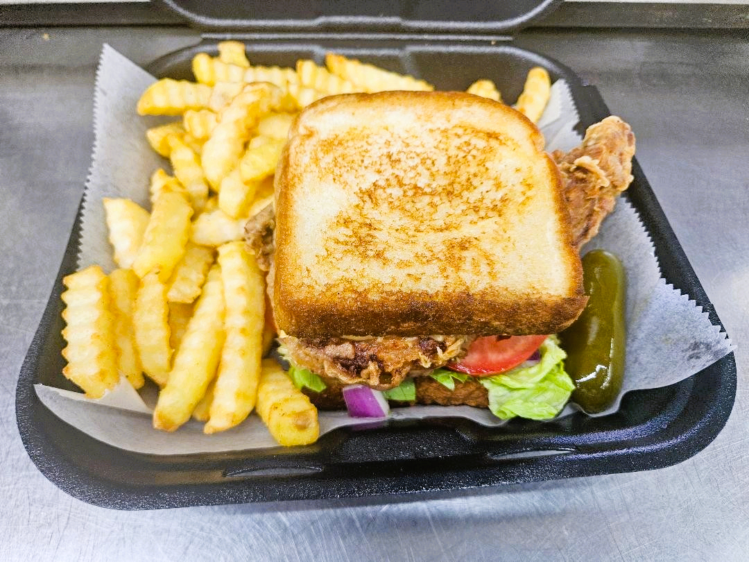 KAJUN PORK CHOP SANDWICH W/ FRIES.