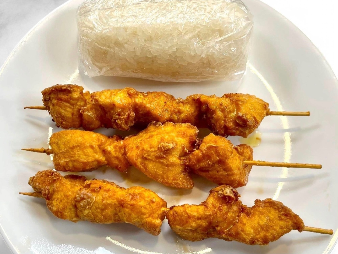 14. Fried Chicken Breast Skewers (3), Sticky Rice, Sauce.