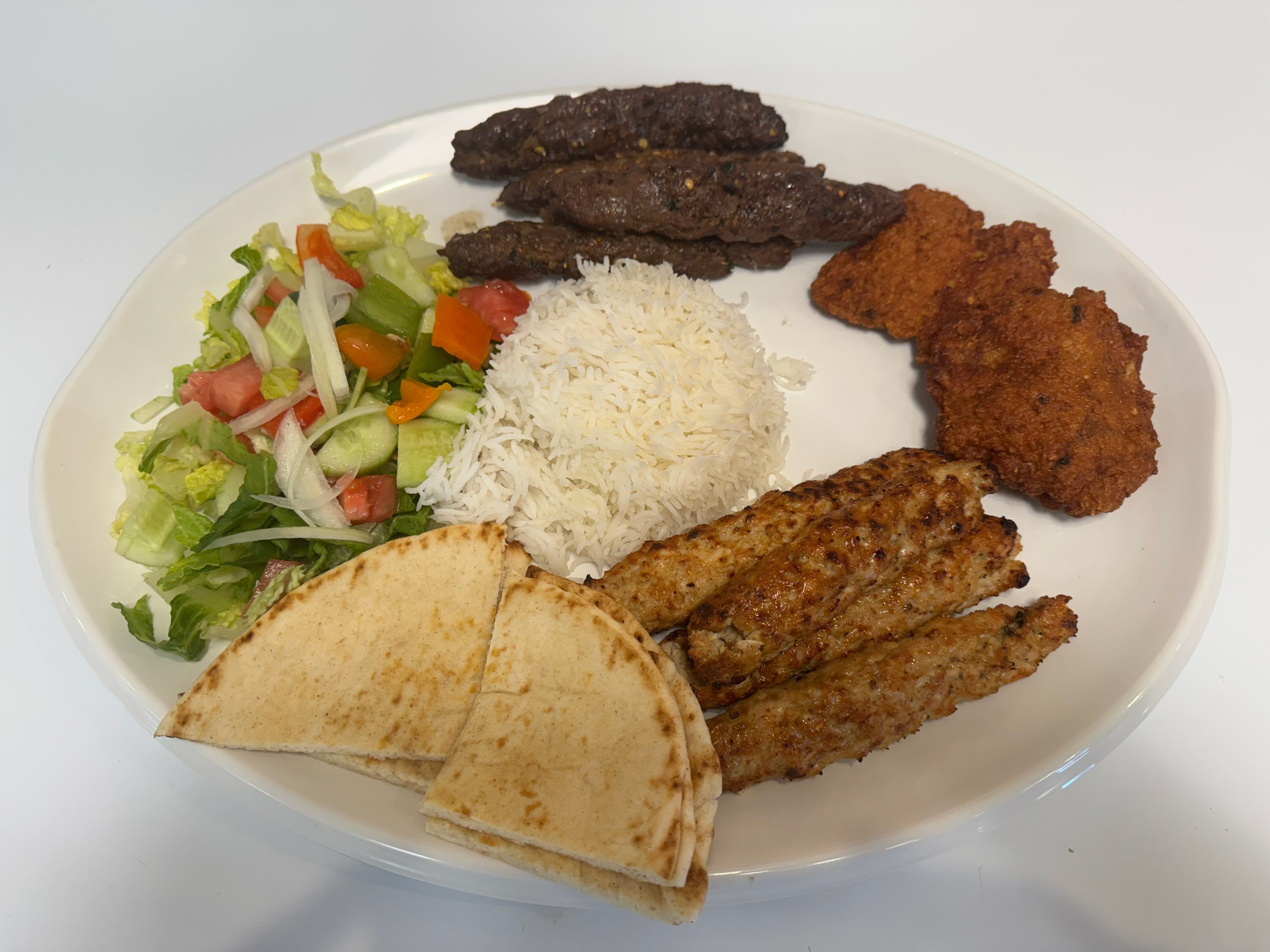 Kabab Platter ( 4 Pice Seekh Beef, 4 Pice Seekh Chicken, 2 Pice Sammi Kabab Or Lamb Kabab, Basmati Rice, Salad, Garlic Dip.