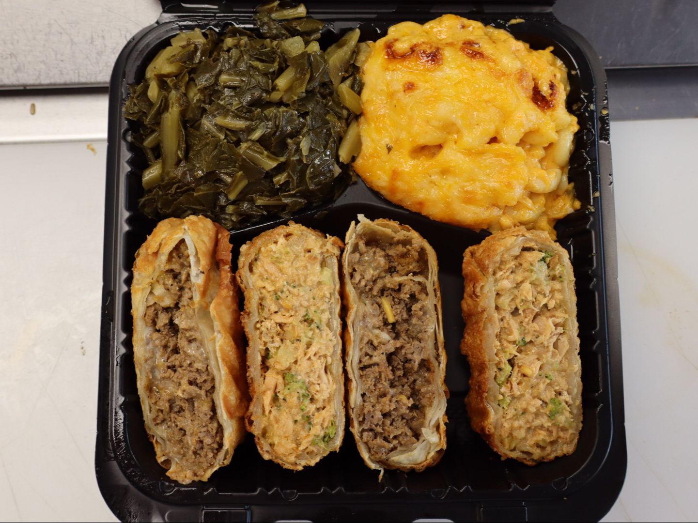 Half cheesesteak & half salmon eggrolls with two sides
