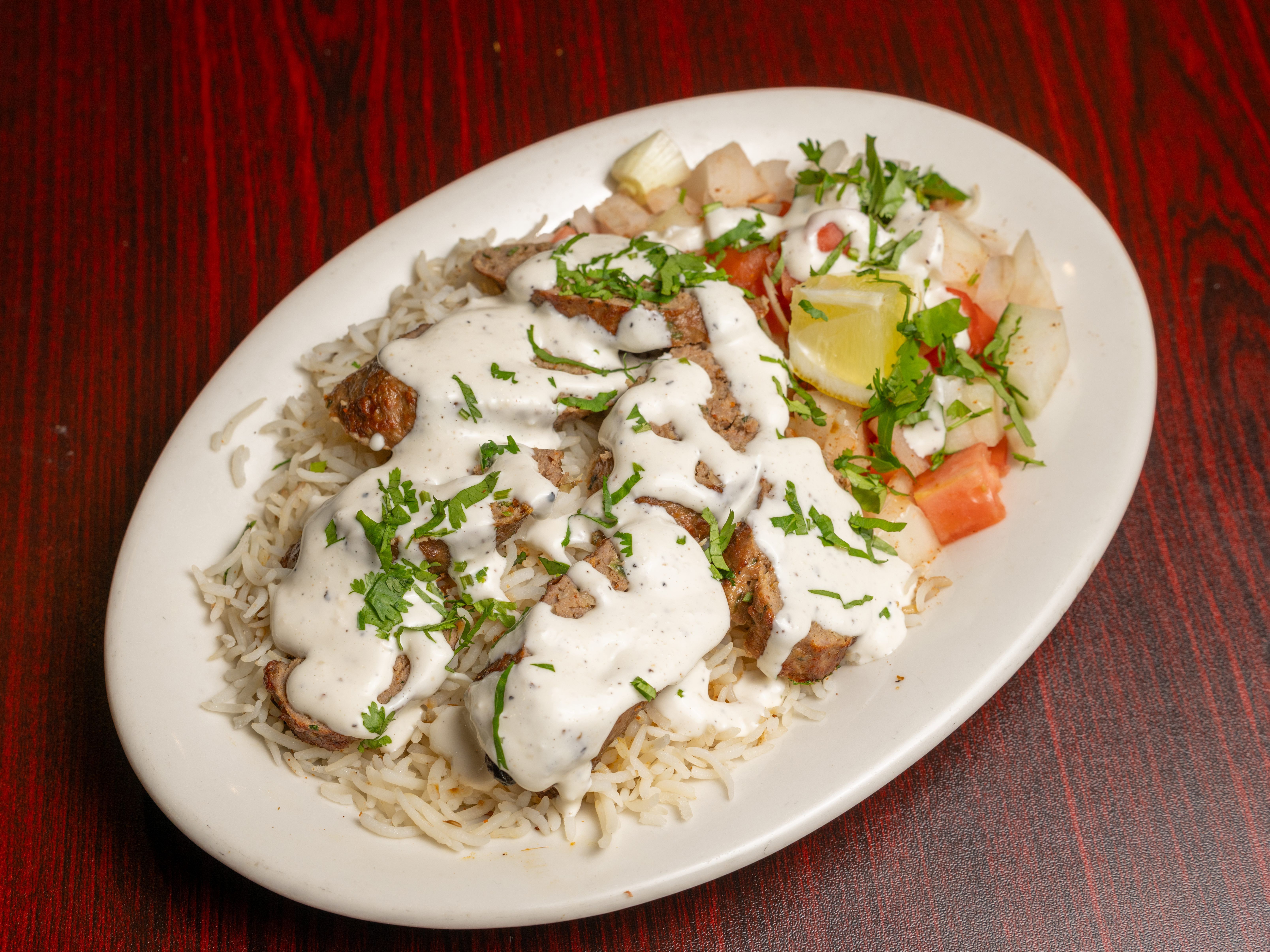 Lamb Seekh Kabob Over Rice.