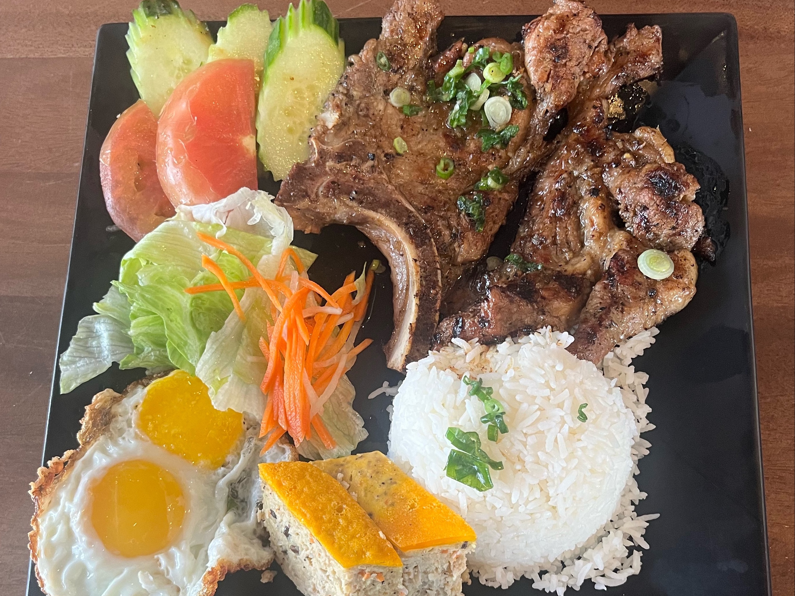 A7. Special Rice Plate - Pork Chop, Egg, and Viet Meatloaf.