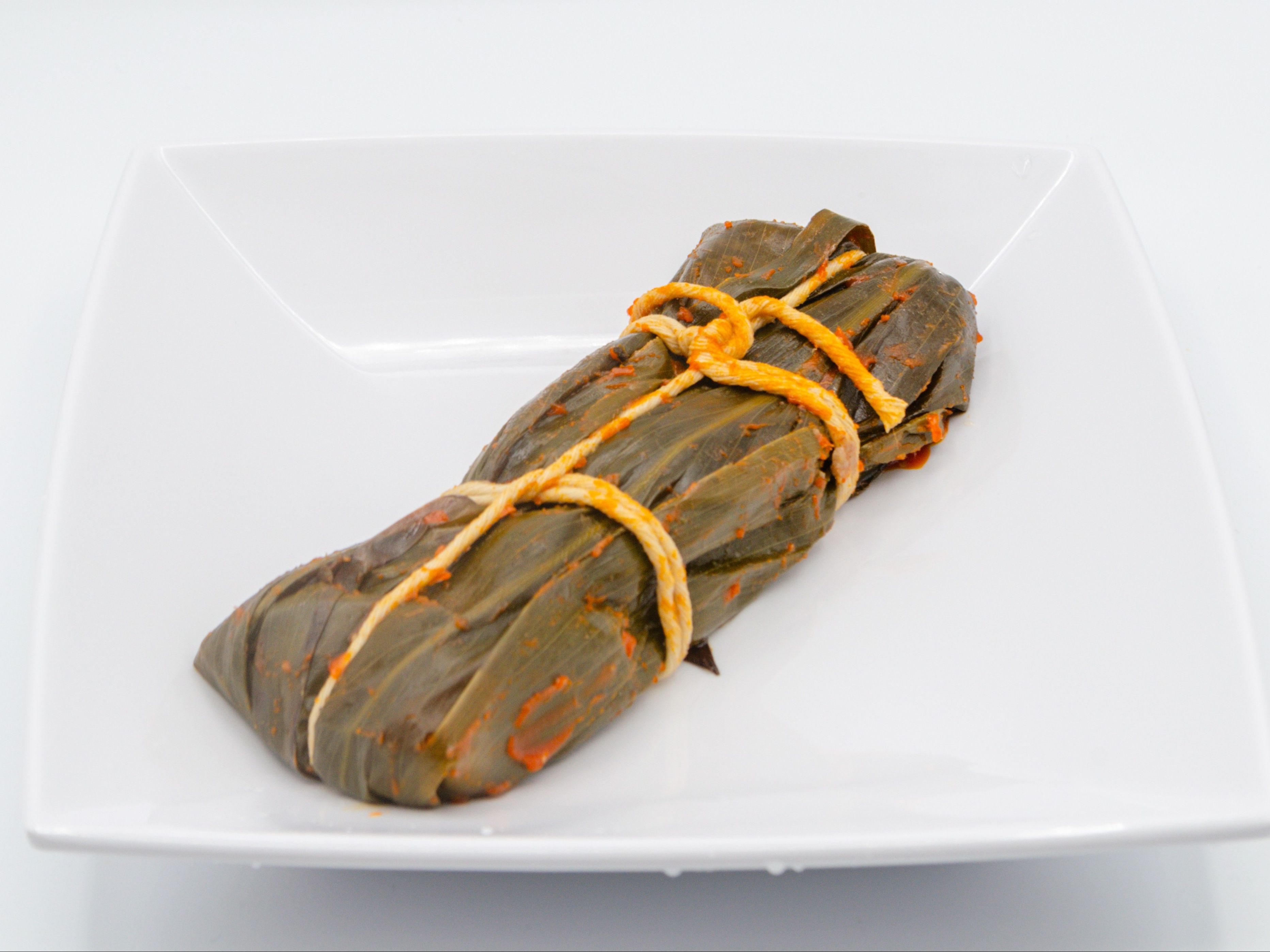 Pasteles - Regular from Yama's Fish Market — One piece of Puerto Rican–inspired local favorite made with seasoned pork and vegetables wrapped in banana leaf.