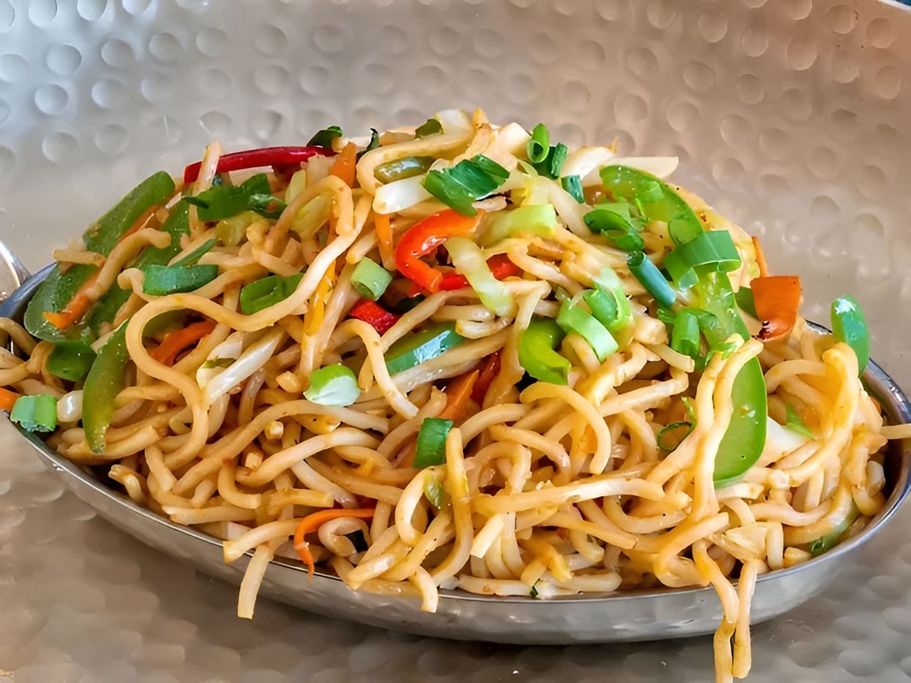 Schezwan Noodles With Veg Manchurian Balls.