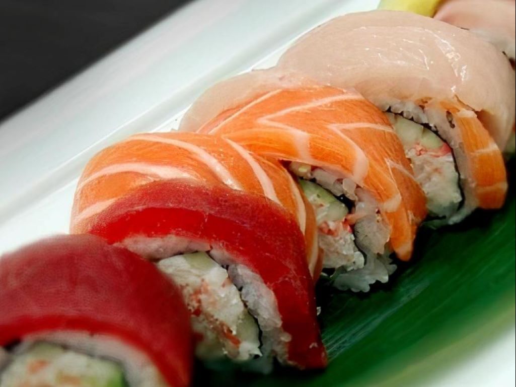 SR10. Rainbow Roll - Crab stick, avocado, cucumber with tuna, salmon, shrimp, white fish & masago outside.